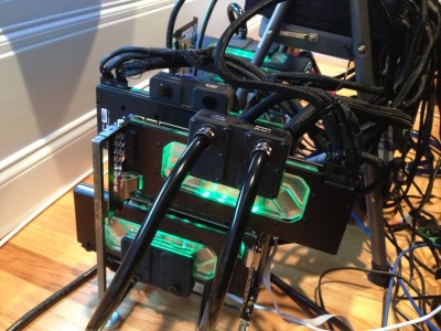3 Watercooled Titan Zs on the Amfeltec 4-Way GPU Cluster - (Swiftech Komodo Waterblock).<br />Tubing runs outside and under the cluster.